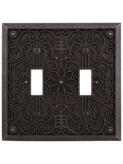 Filigree Double-Toggle Switch Plate in Aged Bronze.